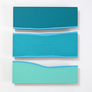 A square-shaped abstract artwork featuring overlapping panels of blue, green, and white colors on a white background.