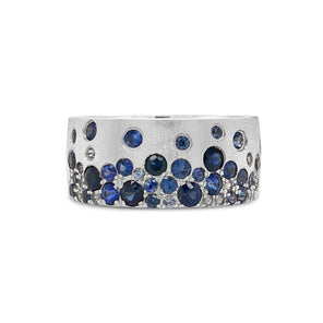 Silver ring with blue gemstones on a white background