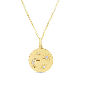 Gold necklace with a round pendant featuring celestial designs on a white background