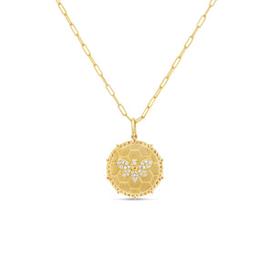 Gold necklace with a round pendant on a white background
