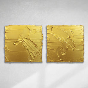 A pair of golden textured paintings by Teodora Guererra hanging on a gallery wall.
