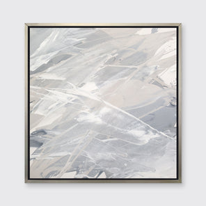 A grey, beige and white abstract print in a silver floater frame hangs on a white wall.