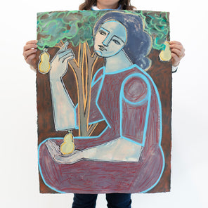 A woman holds an abstracted painting on paper of a woman embracing a tree and holding a pear in her left hand in front of a white wall. 