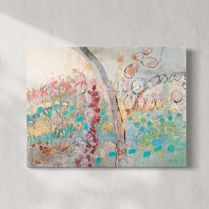 An abstract multicolored painting hangs on a white wall with sunlight cascading over it.