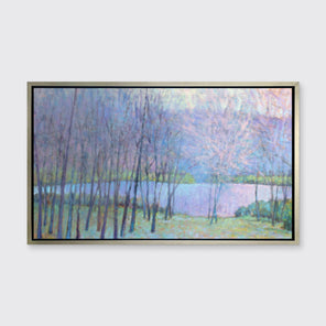 A blue, green and purple abstract landscape print in a silver floater frame hangs on a white wall.
