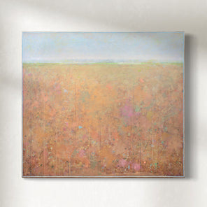 Abstract landscape painting with a high horizon line and soft tones of peach, orange, yellow bottom and blue top hanging on a sunlight wall.