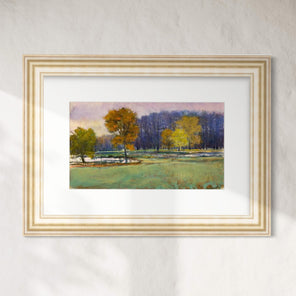 Framed painting of a landscape with trees and a field on a white wall.